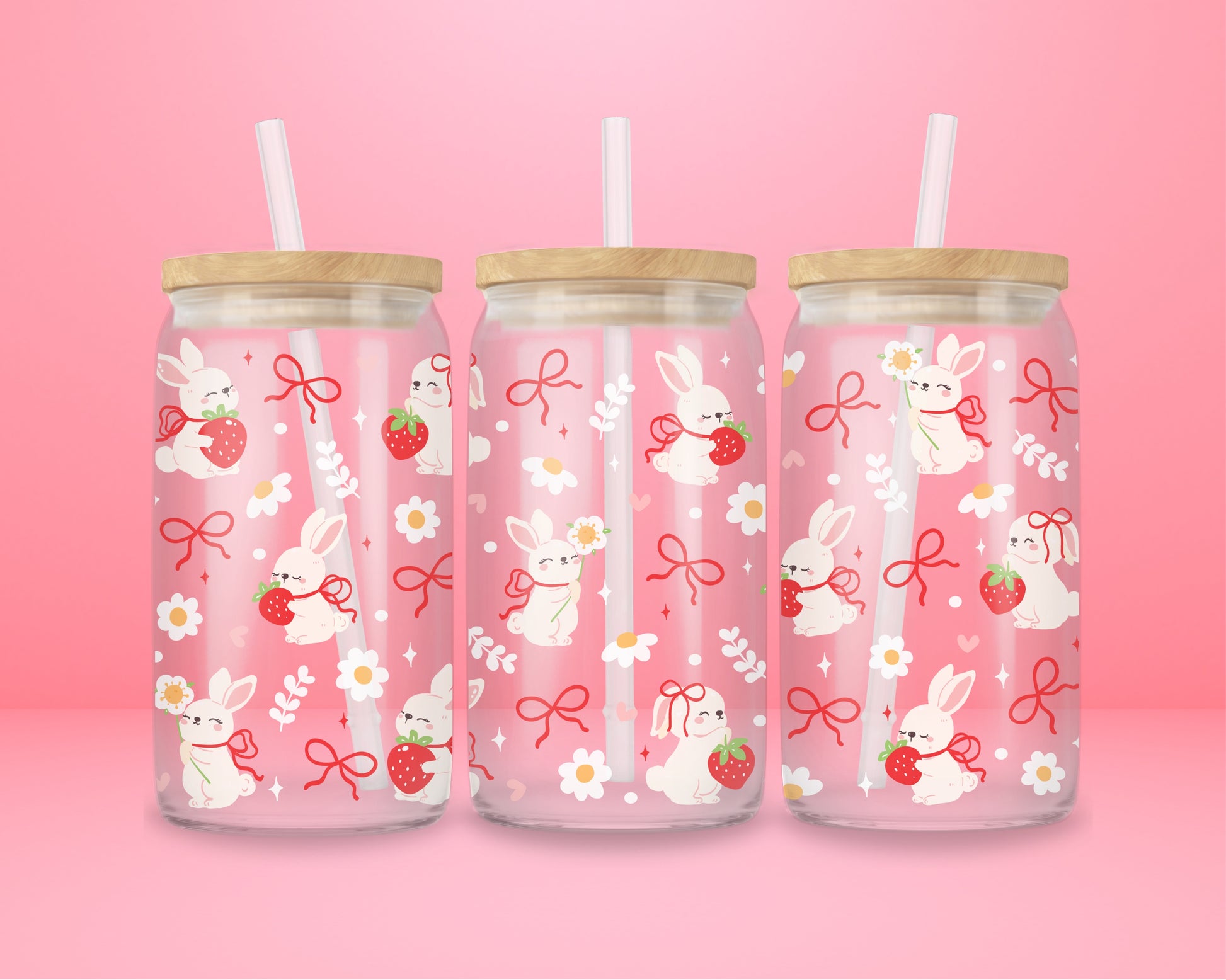 A sweet and soft glass cup covered in bunnies holding strawberries, red bows, white daisies, and hearts. Bunnycore perfection.