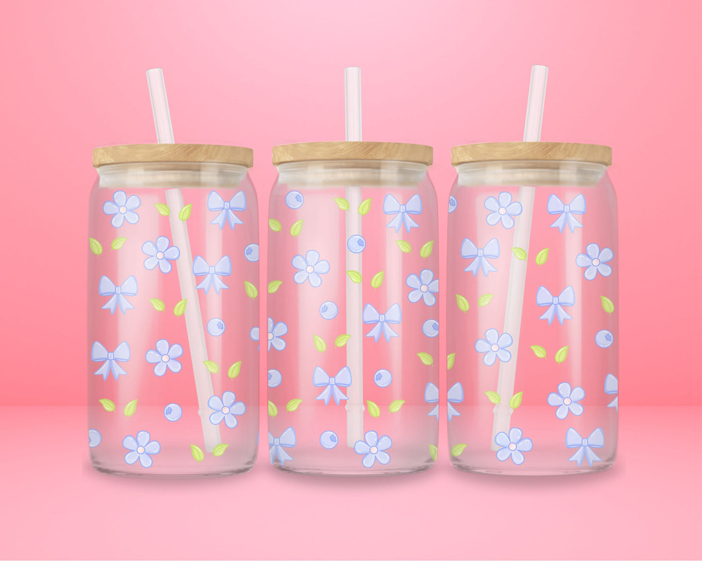 Glass cup featuring a repeating pattern of light blue bows, pastel blue flowers, blueberries, and green leaves on a pink background.