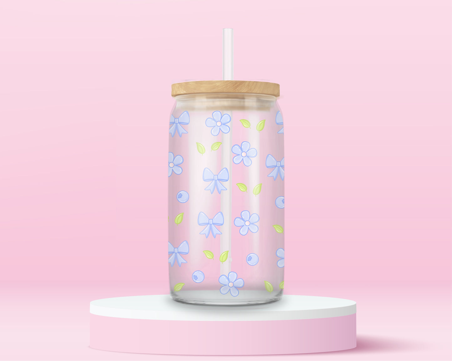 Glass cup featuring a repeating pattern of light blue bows, pastel blue flowers, blueberries, and green leaves on a pink background.