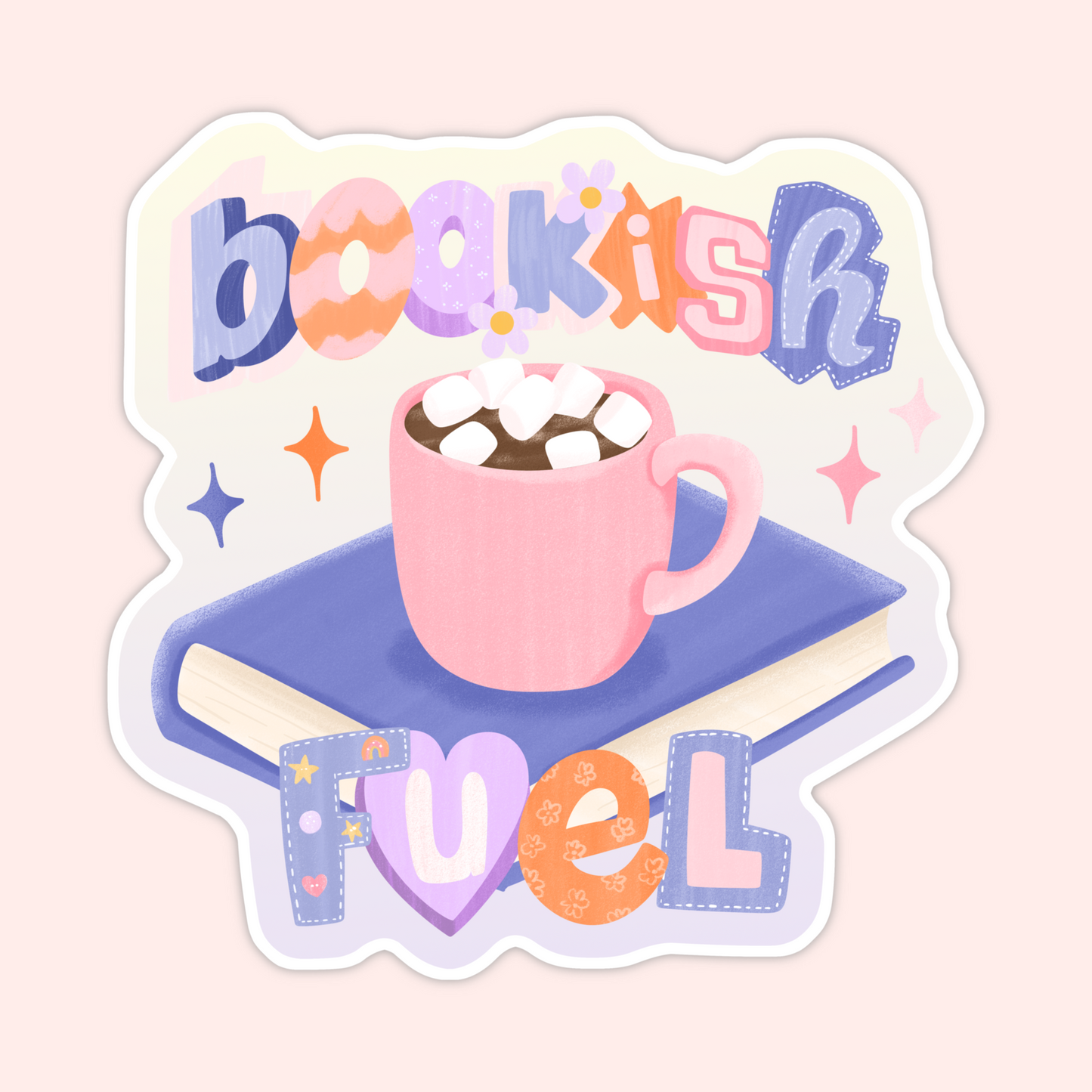 Pink mug of hot chocolate with marshmallows sitting on top of a book with the phrase “bookish fuel” in colorful playful lettering.