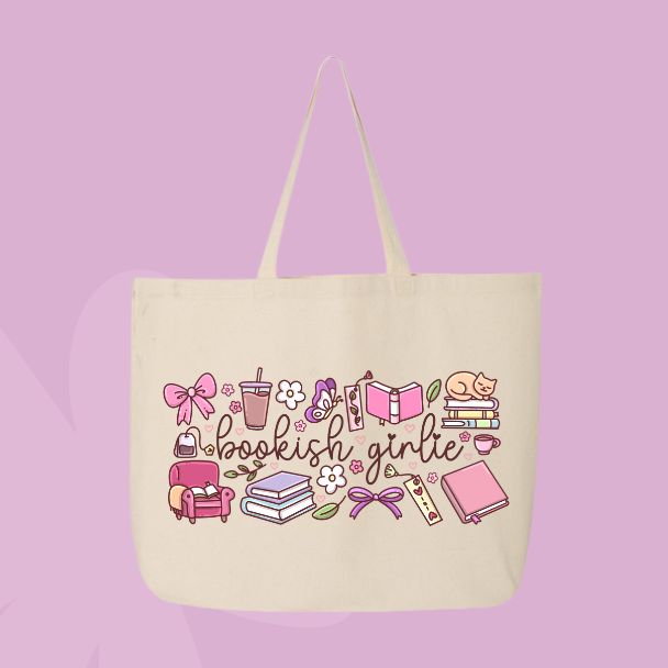 Large beige canvas tote bag featuring the words bookish girlie surrounded by books, bows, coffee cups, flowers, a cozy chair, a cat, and reading-inspired doodles.