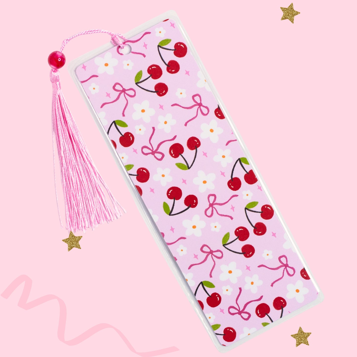 cherry bow bookmark with pink tassel on soft pink background