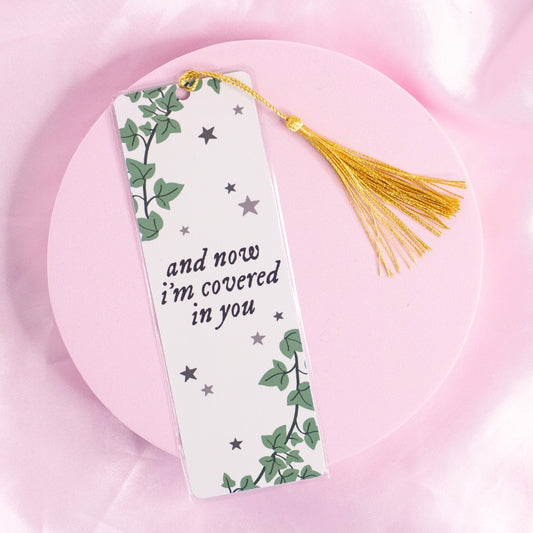 โTaylor Swift-inspired bookmark featuring the quote โand now Iโm covered in youโ with trailing ivy and silver stars โ perfect for poetic, romantic readers and folklore fans.โ