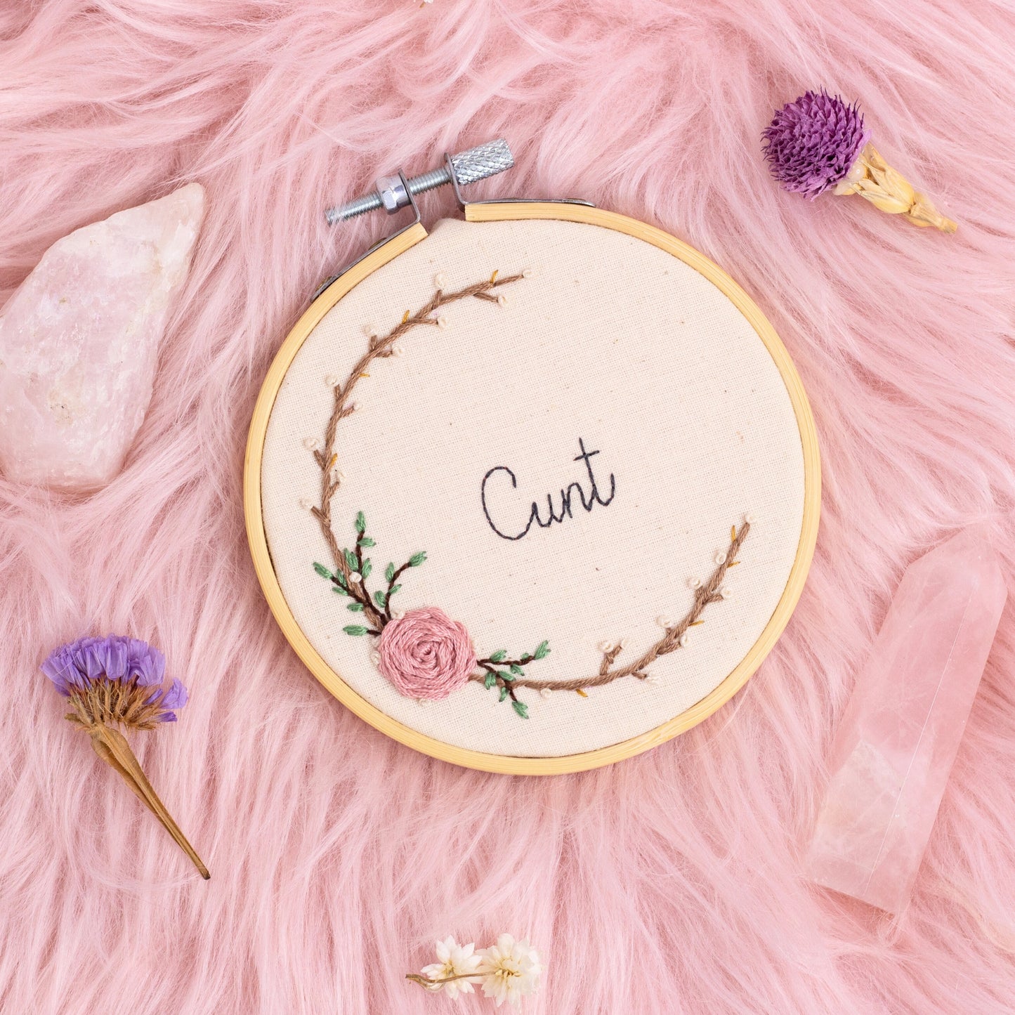 hand embroidered bold feminist quote hoop with floral wreath on pink background