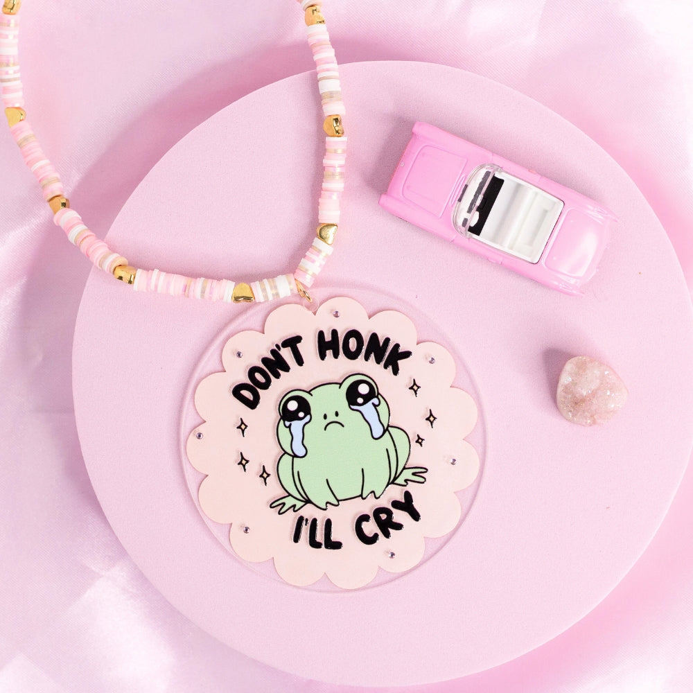 “Kawaii frog car charm with crying face and ‘Don’t honk I’ll cry’ quote – adorable and relatable.”