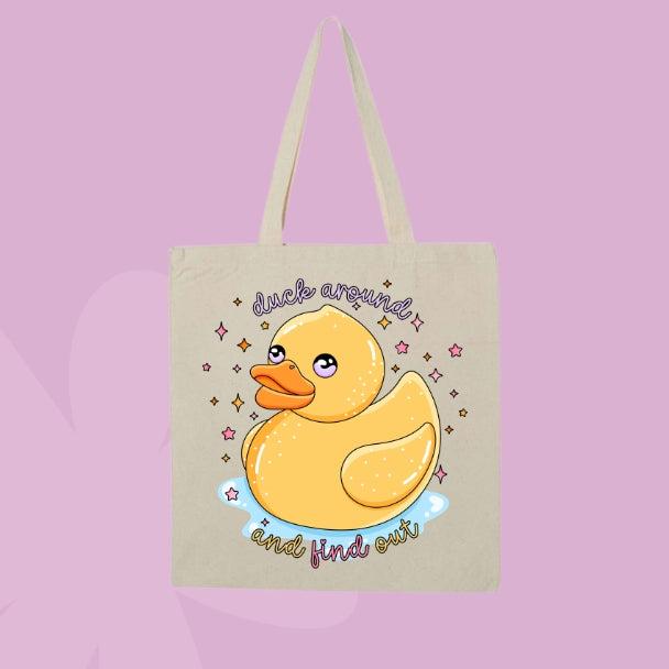 Beige canvas tote bag featuring a cute yellow rubber duck with sparkles and text that says duck around and find out.