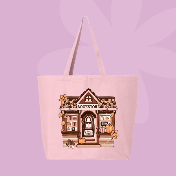Pink tote bag with a cozy autumn bookstore illustration decorated with pumpkins, books, and fall leaves.