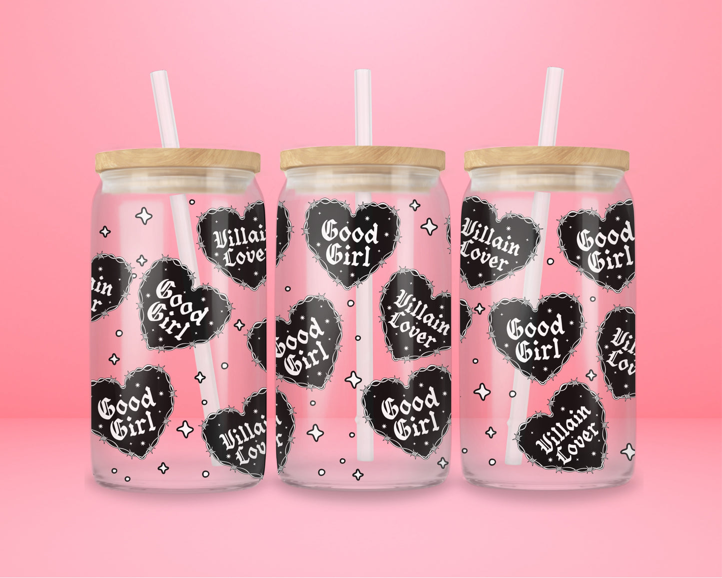Glass can tumbler with bamboo lid and glass straw featuring black gothic heart designs with the words Good Girl and Villain Lover on a pink background.