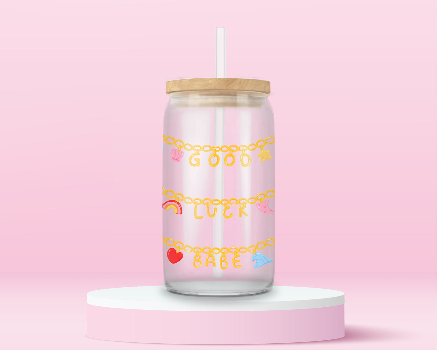 Glass tumbler with charm chains spelling good luck babe with colorful lucky symbols.
