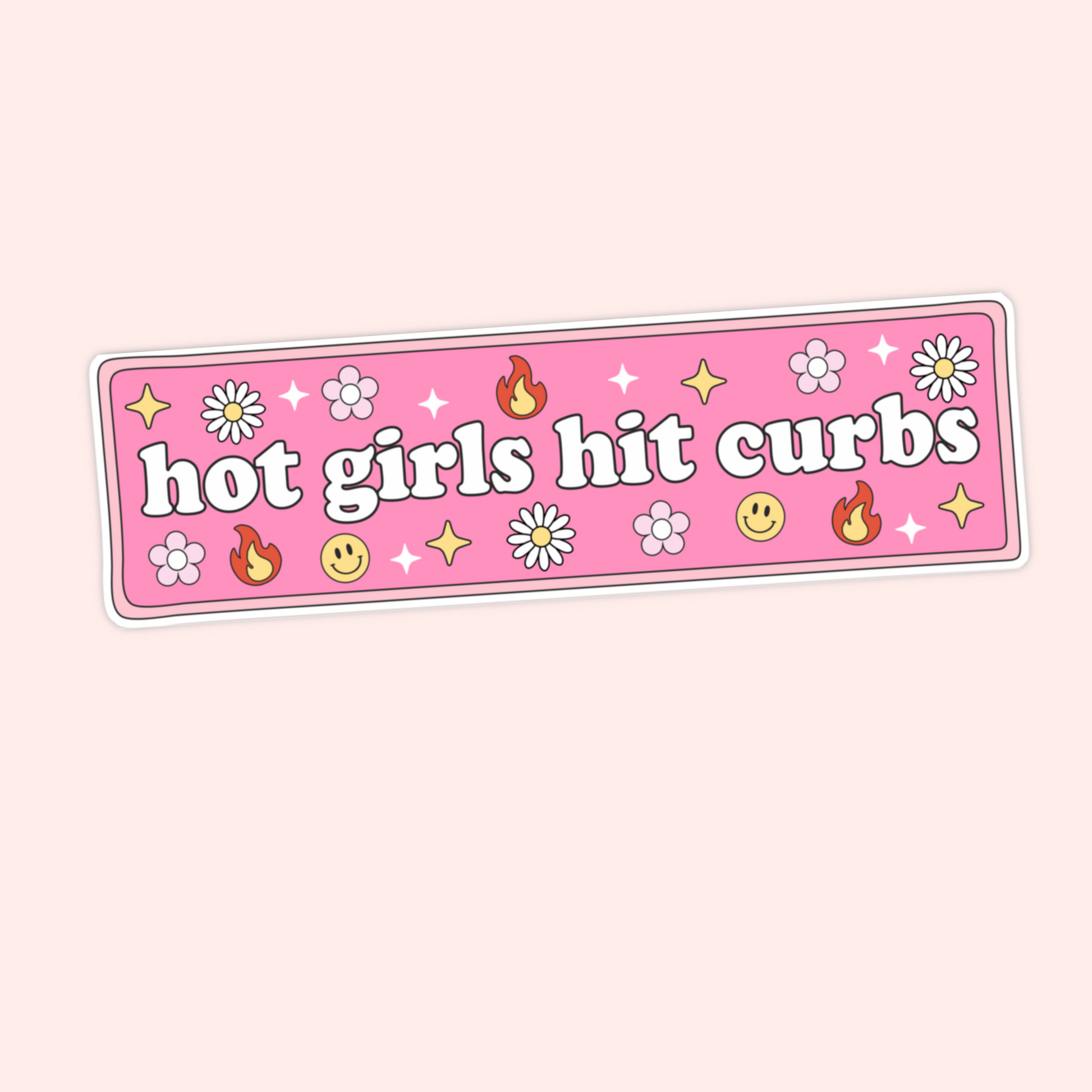 A hand holding a pink bumper sticker that says "hot girls hit curbs" surrounded by daisies, flames, smiley faces, and sparkles.