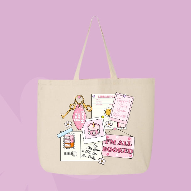 Beige tote bag with a pink collage design featuring a library card, candle, and text that says โIโm All Booked.โ