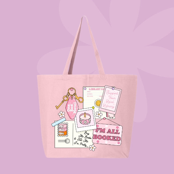 Pink tote bag with a pink collage design featuring a library card, candle, and text that says โIโm All Booked.โ