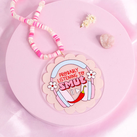 โCar charm with pastel headphones and โProbably listening to smutโ quote โ spicy bookish accessory for audiobook lovers.โ