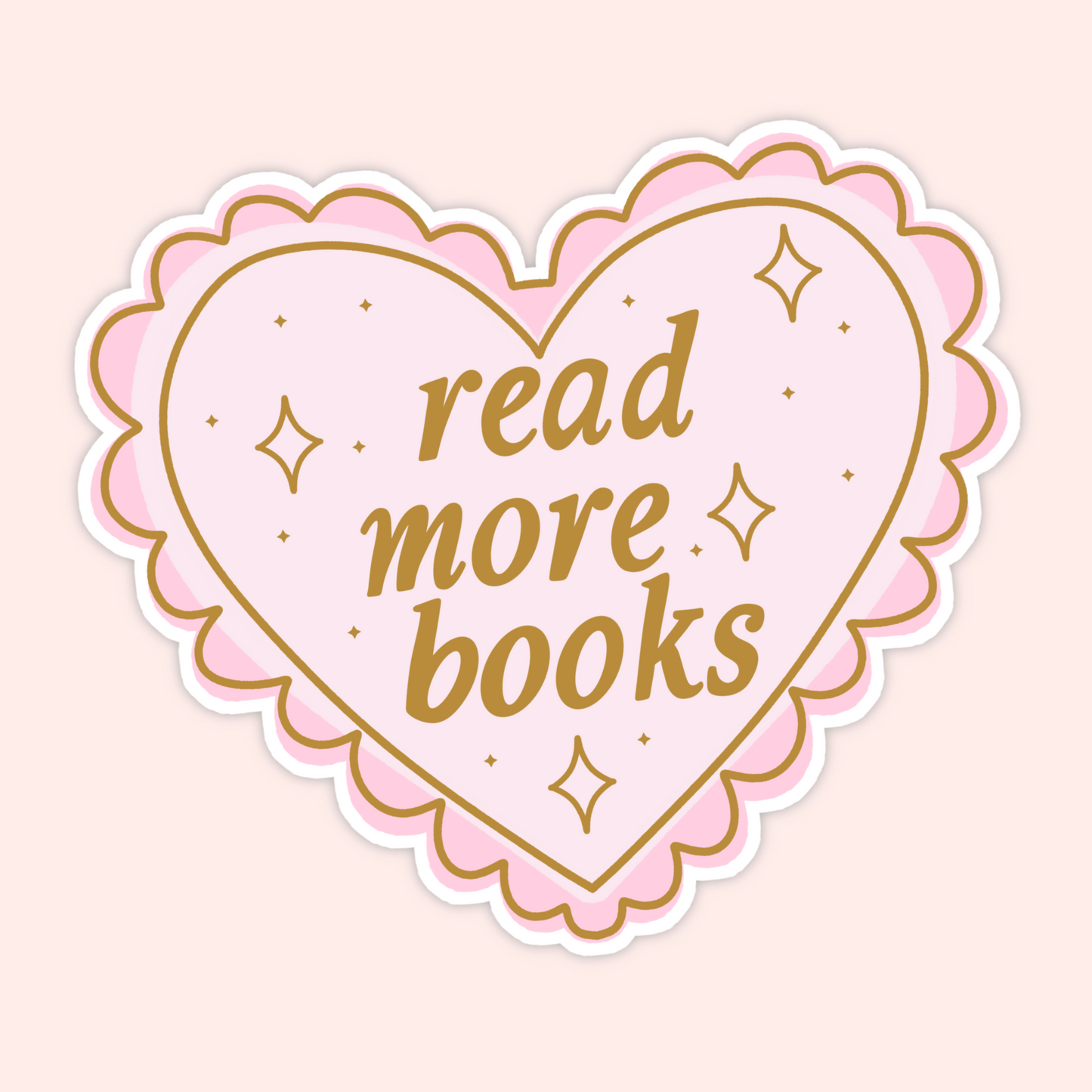 Pink scalloped heart sticker with gold lettering that reads “Read More Books.”