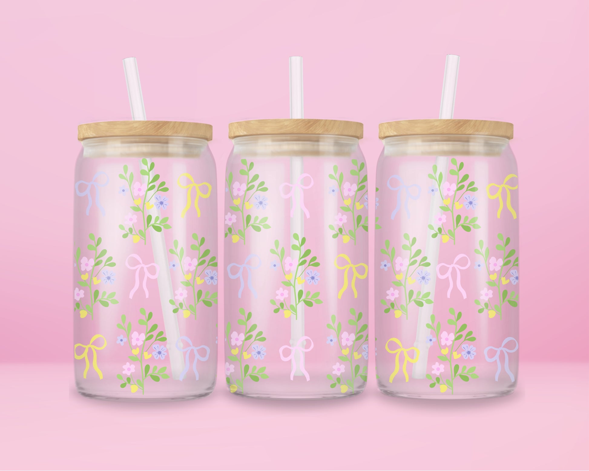 A pink glass cup with pastel-colored bows and dainty floral vines. Light, fresh, and blooming with springtime charm.