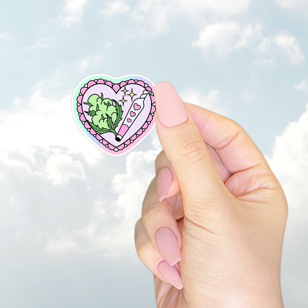 A heart-shaped pastel sticker featuring green leafy weed and a pink lighter with heart details and sparkles. Playfully cute and perfect for cannabis lovers with a girly side.