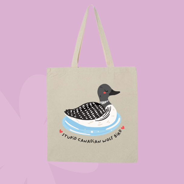 Funny Canadian themed tote bag with illustrated loon floating on water and text reading stupid Canadian wolf bird.