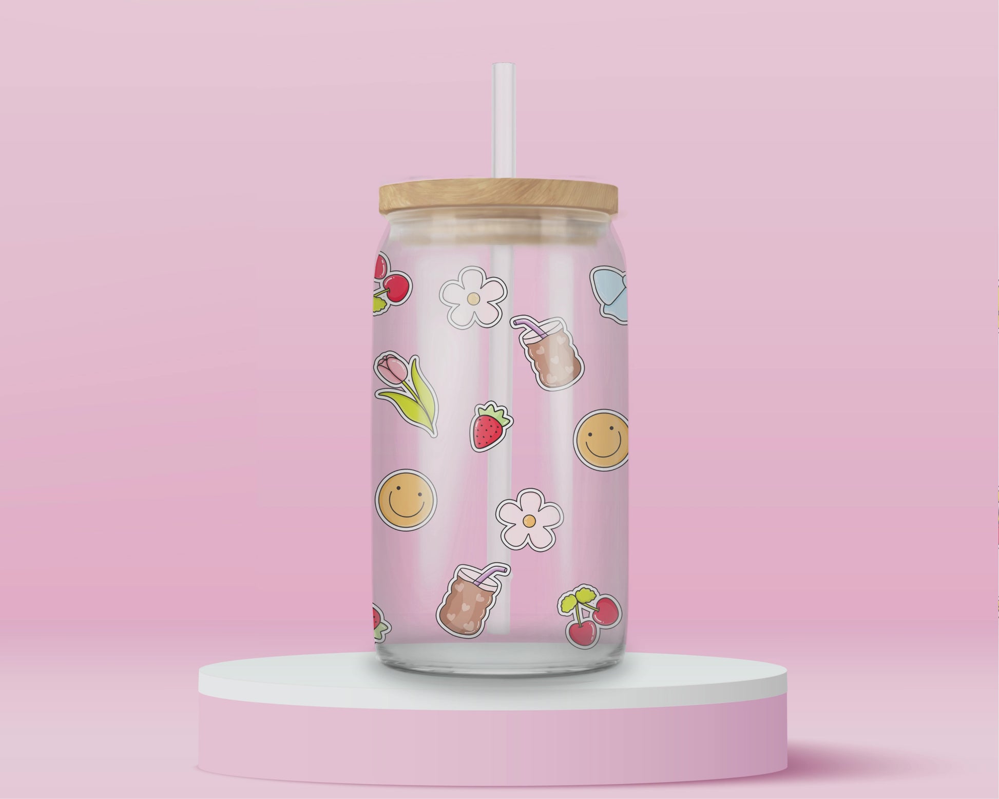 Glass cup with iced coffee cups, cherries, blue bows, tulips, strawberries, smiley faces, and white flowers scattered on a pink background.
