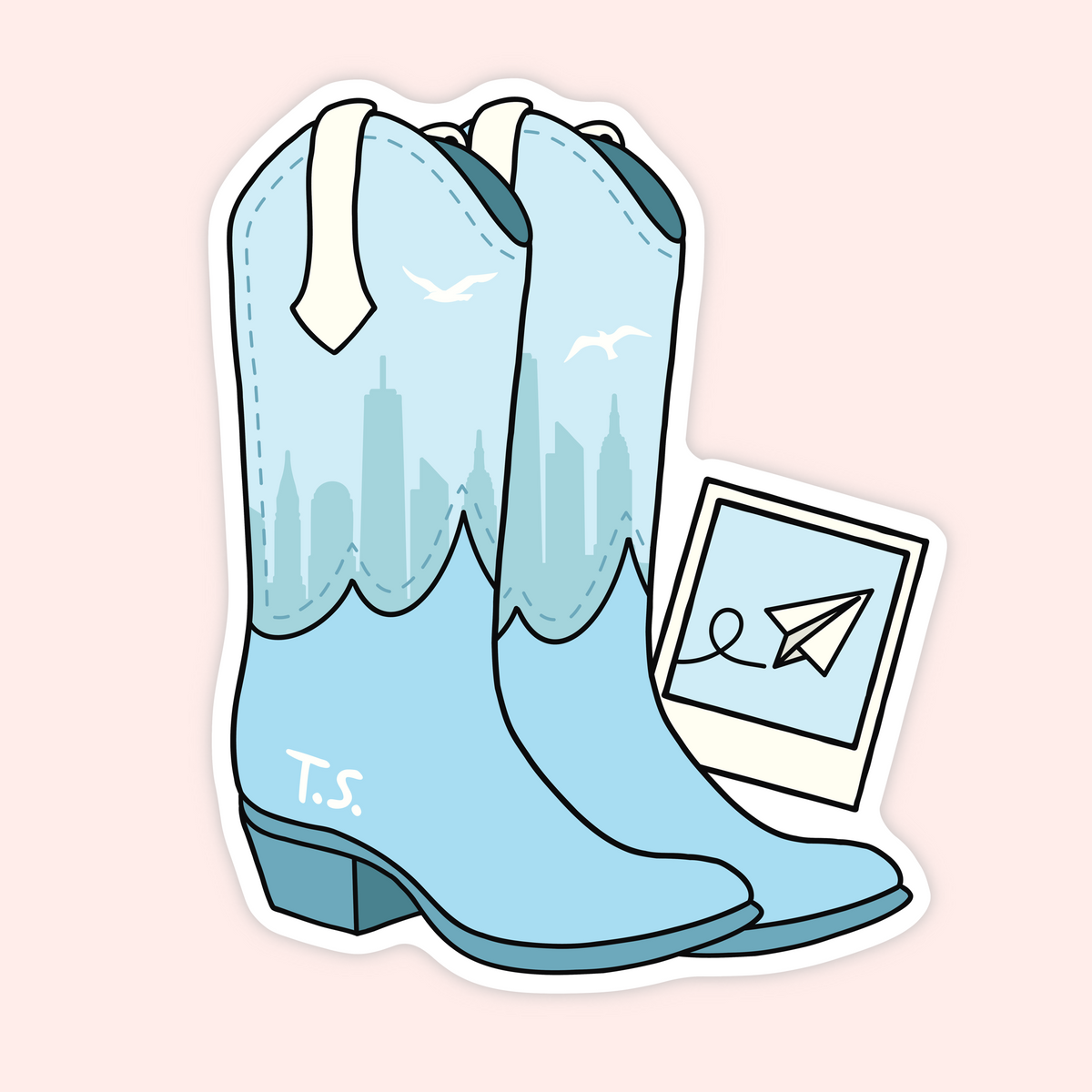 A die-cut sticker featuring a pair of light blue cowboy boots with a city skyline printed on the shafts, white pull tabs, and the initials 'T.S.