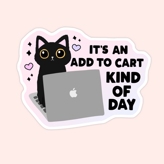 Black cat sitting at a laptop with the phrase "It’s an add to cart kind of day."