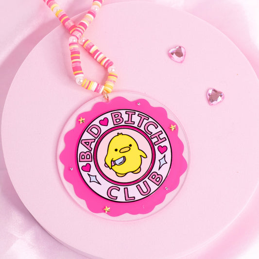 “Bright pink car charm with sassy duck and ‘Bad Bitch Club’ quote – empowering and hilarious statement piece.”
