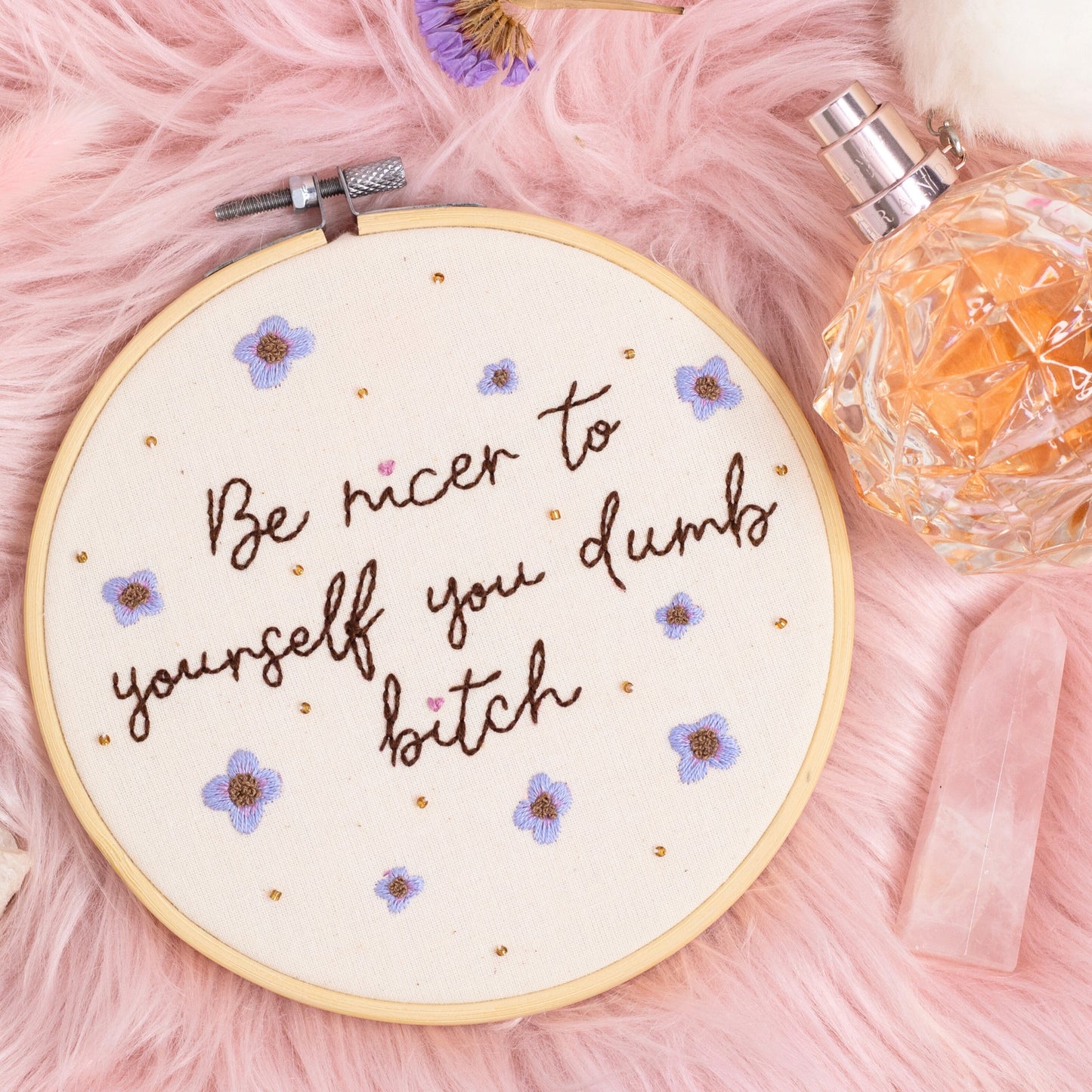 Be nicer to yourself you dumb bitch hand embroidered quote hoop with purple flowers on pink background