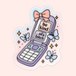 Illustrated purple flip phone with a bow and butterflies displaying the phrase “be kind of a bitch” in a soft pastel aesthetic.