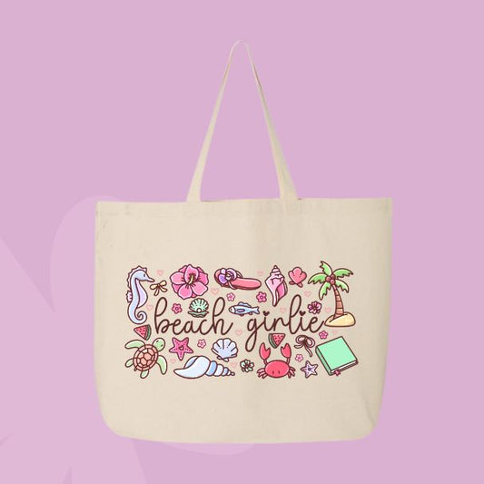 Large beige canvas tote bag featuring the words beach girlie surrounded by seashells, hibiscus flowers, palm trees, sea creatures, watermelon, and coastal doodles.