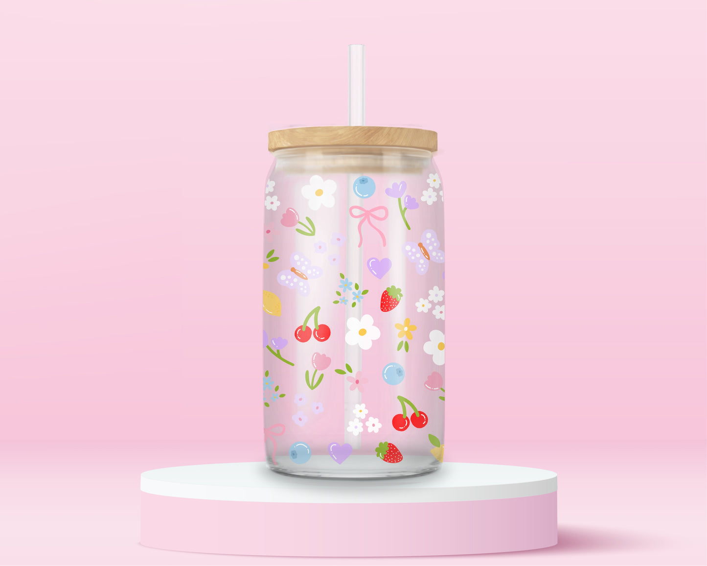 Clear glass can tumbler with a soft pink background, covered in cherries, strawberries, lemons, flowers, bows, and pastel doodles for a sweet garden-inspired look.