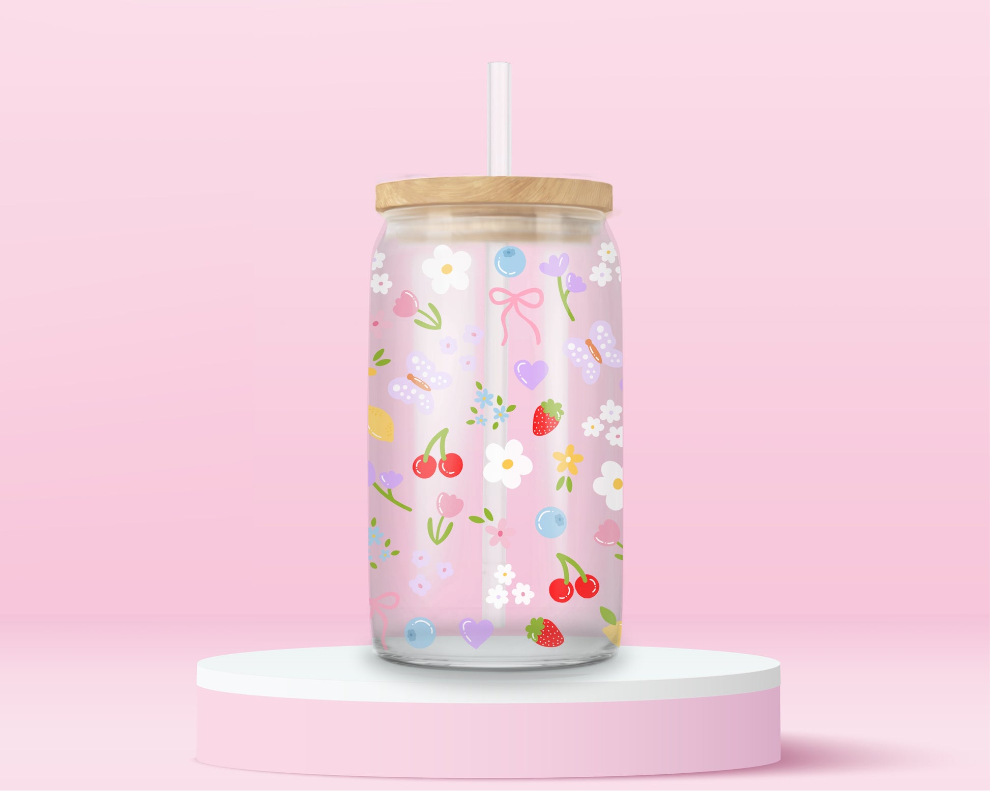 Clear glass can tumbler with a soft pink background, covered in cherries, strawberries, lemons, flowers, bows, and pastel doodles for a sweet garden-inspired look.