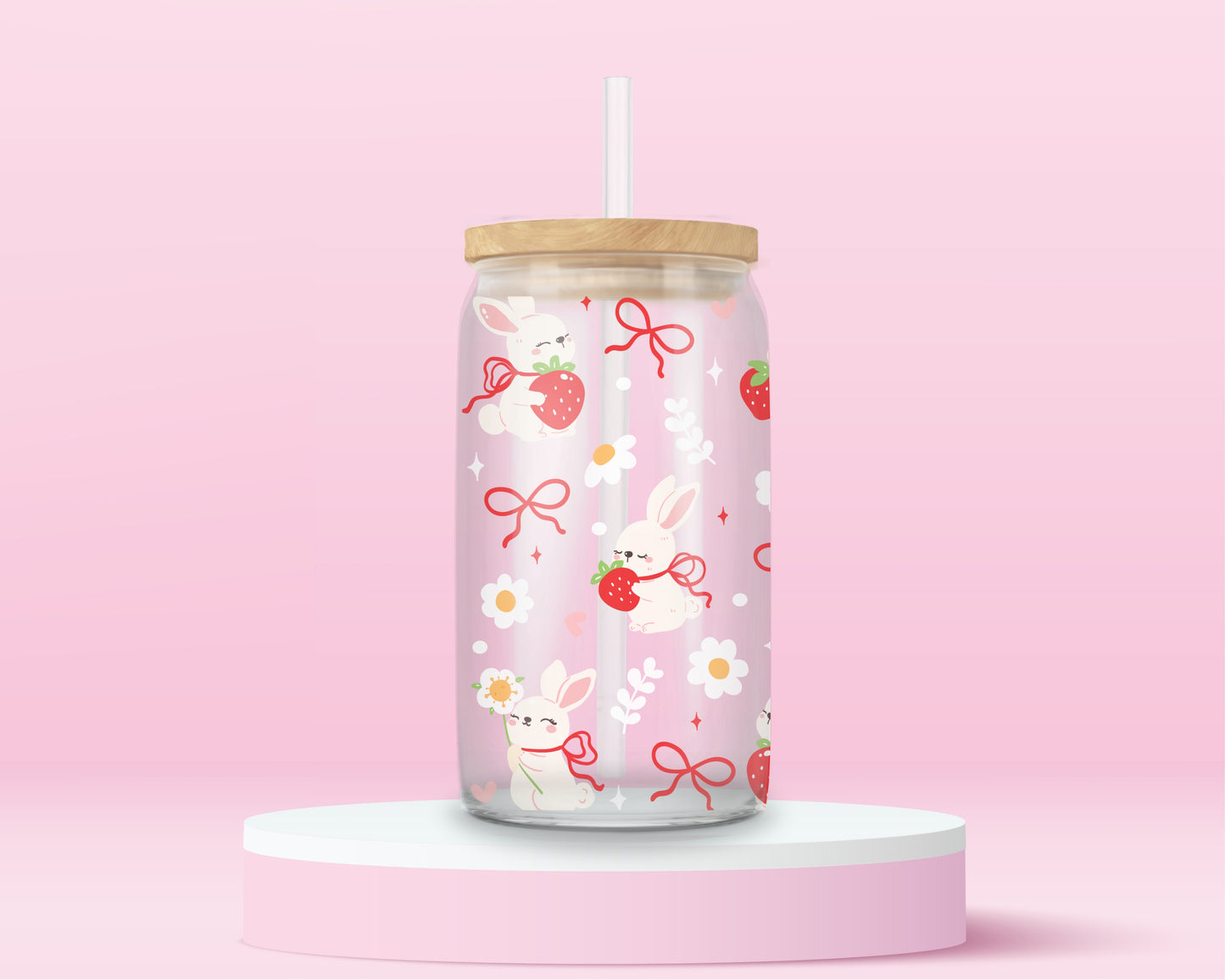 A sweet and soft glass cup covered in bunnies holding strawberries, red bows, white daisies, and hearts. Bunnycore perfection.