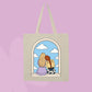 Beige canvas tote bag featuring two girls sitting together in an arched window with clouds and a blue sky.