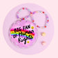 rainbow heart acrylic car charm with pink glitter background and colorful beaded hanger