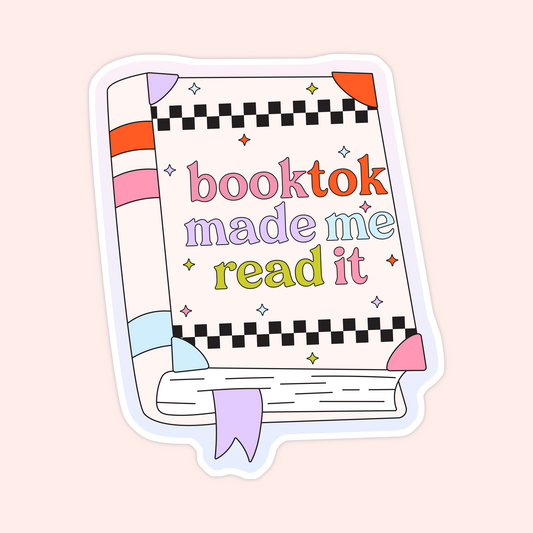 Colorful sticker shaped like a book with the words “booktok made me read it” in rainbow letters and checkered accents.