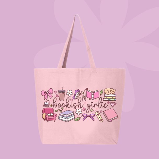 Large pink canvas tote bag featuring the words bookish girlie surrounded by books, bows, coffee cups, flowers, a cozy chair, a cat, and reading-inspired doodles.