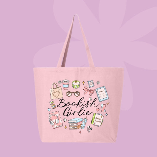Pink tote bag with doodles of cozy items like books, coffee, candles, bows, glasses, and text that says “Bookish Girlie.”