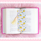 bunny lemon bookmark with yellow tassel styled on open book with pink aesthetic background