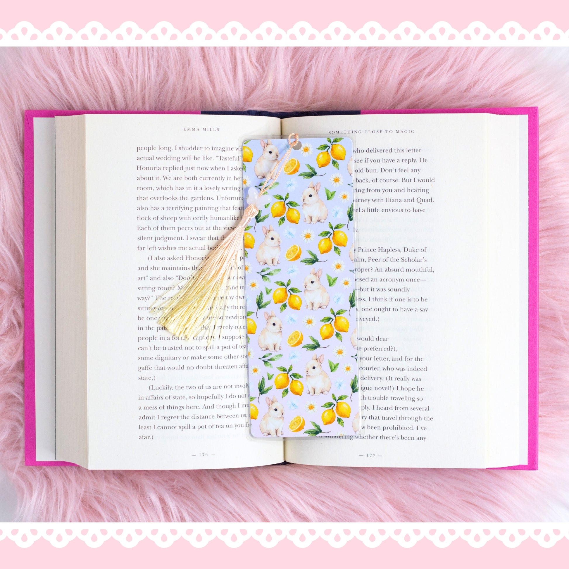 bunny lemon bookmark with yellow tassel styled on open book with pink aesthetic background