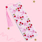 cherry bow bookmark with pink tassel on soft pink background