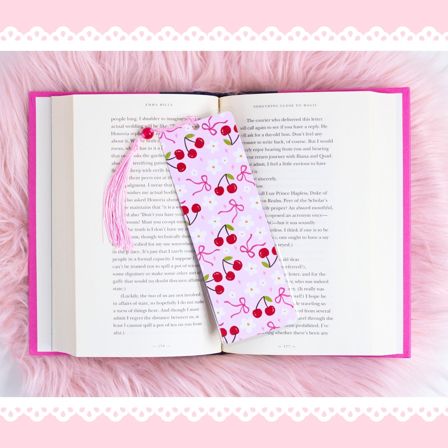 cherry coquette bookmark with bows and flowers placed on open book with pink aesthetic background