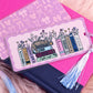 taylor swift eras inspired book stack bookmark with floral books and tassel styled on pink aesthetic background