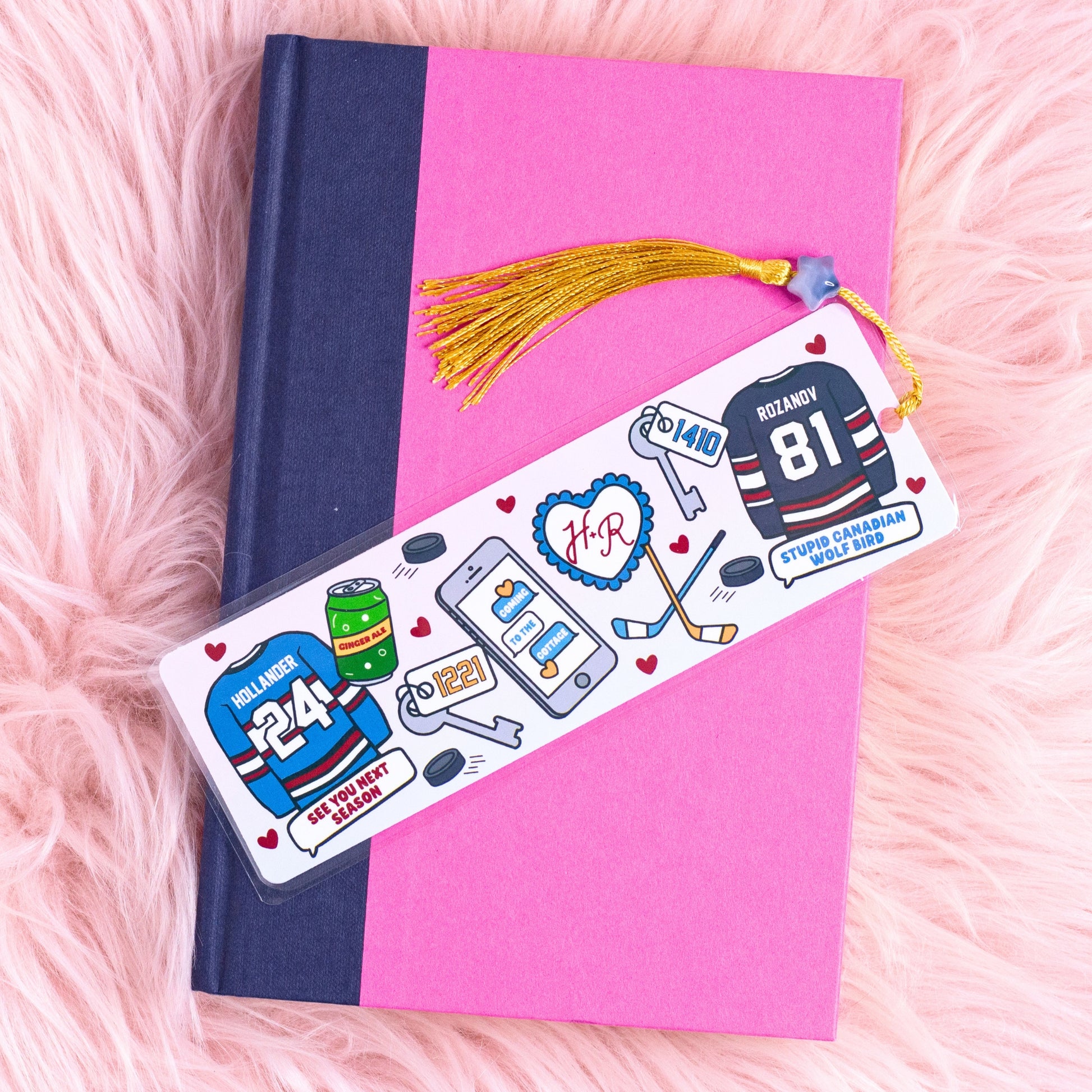 heated rivalry hockey romance bookmark with illustrated jerseys sticks and hearts on pink aesthetic background