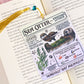 sea otter illustrated bookmark with vintage style marine design resting inside open book on pink background