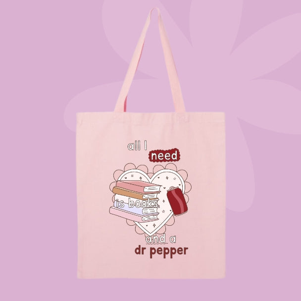 Canvas tote bag with book stack graphic and phrase all I need is books and a Dr Pepper.