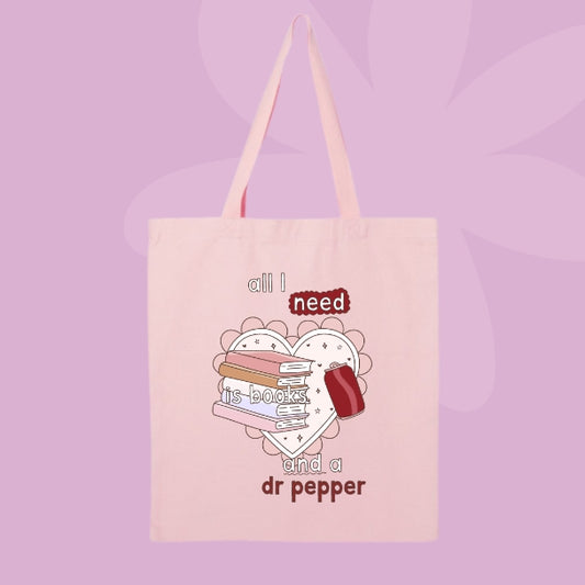 Canvas tote bag with book stack graphic and phrase all I need is books and a Dr Pepper.