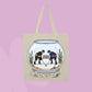 Beige canvas tote bag featuring two hockey players inside a fishbowl aquarium with the words the boy aquarium.
