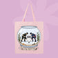Pink canvas tote bag featuring two hockey players inside a fishbowl aquarium with the words the boy aquarium.