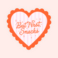 Orange scalloped heart sticker with pink stripes that says “But first, snacks,” cute foodie aesthetic sticker.