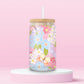 Glass tumbler covered in colorful butterflies and pastel flowers, with bamboo lid and straw.