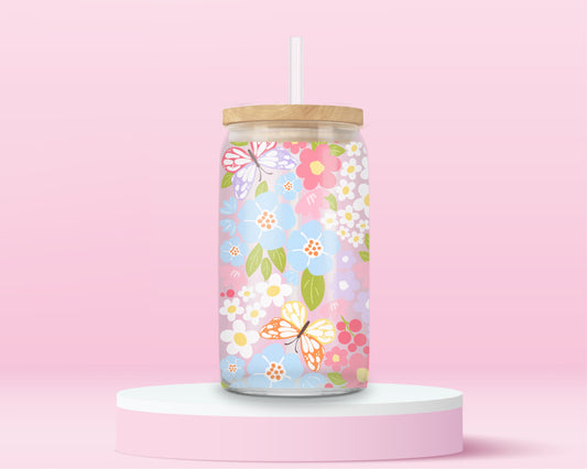 Glass tumbler covered in colorful butterflies and pastel flowers, with bamboo lid and straw.